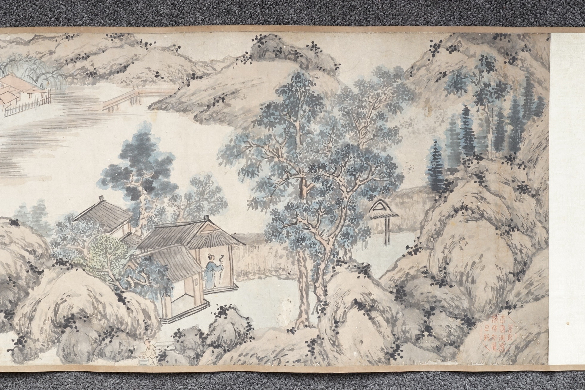 Chinese School , (Qing dynasty), Figures in a mountainous river landscape, Ink and colour on paper handscroll, 268.5cm x 29cm excluding borders